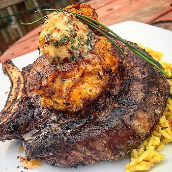 Grilled Ribeye with Smoked Creole Butter and Crawfish Crab Cakes recipe